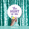 Load image into Gallery viewer, Hand holding a sign with 'The Hunt is On' text for Easter events and parties egg hunts and religious easter by Lush Party Studio