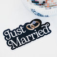 Load image into Gallery viewer, Decorative sign with 'Just Married' text and wedding rings, next to a disco ball on a white background.
