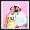 Load image into Gallery viewer, Two people posing with a photo booth prop sign that reads 'Let's Dance on the Tables' against a pink background.