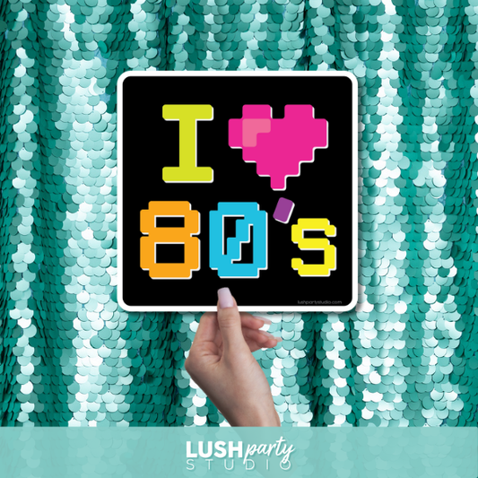 80s photo booth prop sign with 'I ❤️ 80s' text by Lush Party Studio 