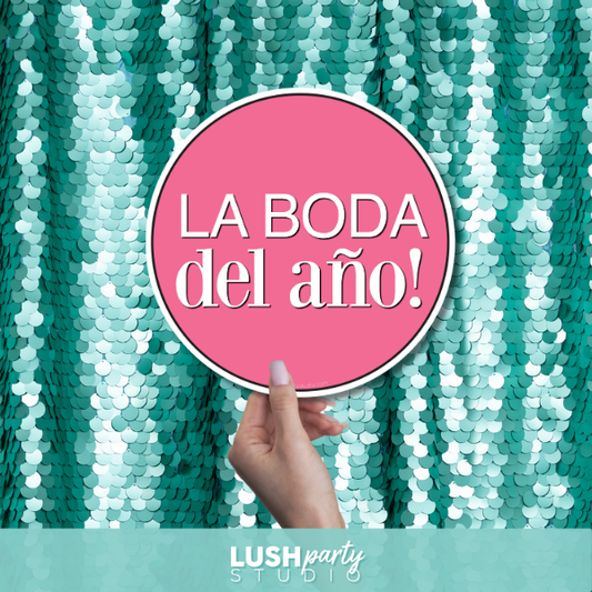 Hand holding a pink sign with 'LA BODA del ano!' text against a teal sequin background, Lush Party Studio branding visible.