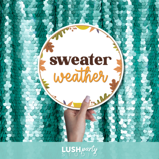 photo booth prop sign with 'sweater weather' text by lush party studio