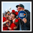 Load image into Gallery viewer, Family posing with a 'Hot Shot' photo booth prop sign and sports-themed events
