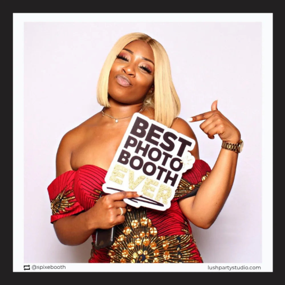 Woman holding a sign that says 'Best Photo Booth Ever' by lush party studio