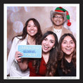 Load image into Gallery viewer, Four people posing with a photo booth prop sign by lush party studio
