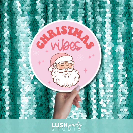 Pink Christmas photo booth prop with 'Christmas Vibes' text by lush party studio