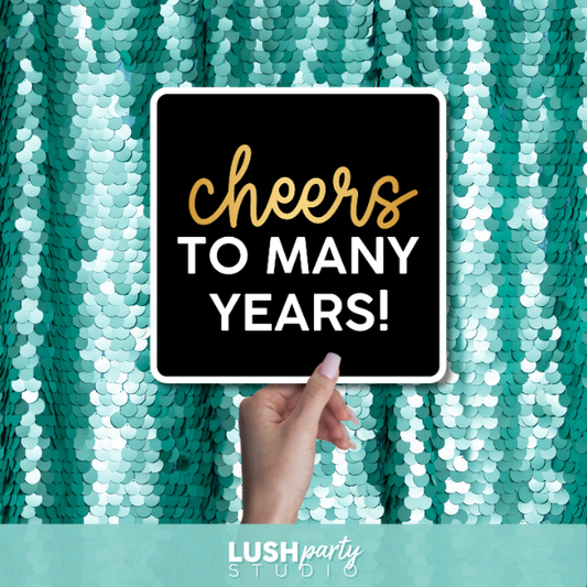 classy birthday photo booth prop sign with 'Cheers to Many Years!' text by lush party studio