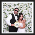 Load image into Gallery viewer, Couple holding a 'Just Married' prop sign in front of a floral backdrop
