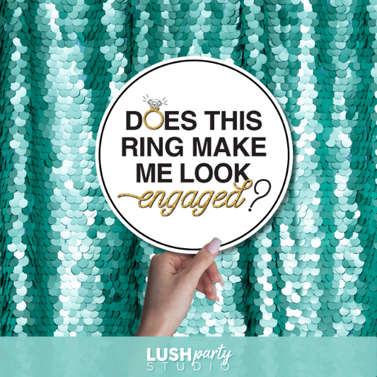 wedding engagement photo booth prop sign with 'Does this ring make me look engaged?' text by lush party studio