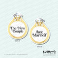 Load image into Gallery viewer, Two gold ring-shaped signs with 'The New Couple' and 'Just Married' text for photobooth props by Lush Party Studio branding.
