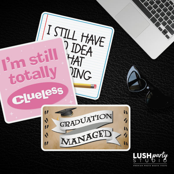 Three funny sayings for grads, graduation photobooth props by lush party studio on a dark surface with a laptop and sunglasses.