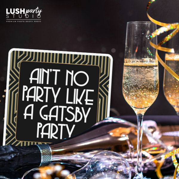 Gatsby-themed party setup with champagne and prop sign by lush party studio
