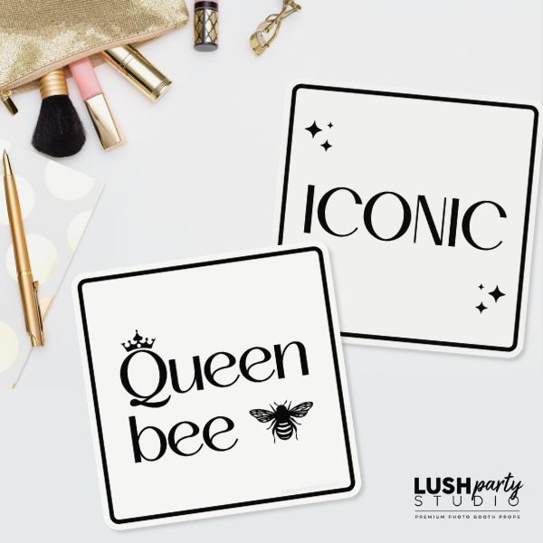 Two black and white photo booth prop signs with 'Queen bee' and 'Iconic' text by lush party studio