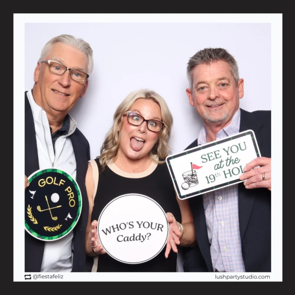Three people holding golf prop signs in a photo booth by Lush Party Studio.