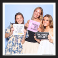 Load image into Gallery viewer, Three women holding photo booth prop signs with graduation phrases in a photo booth setting.
