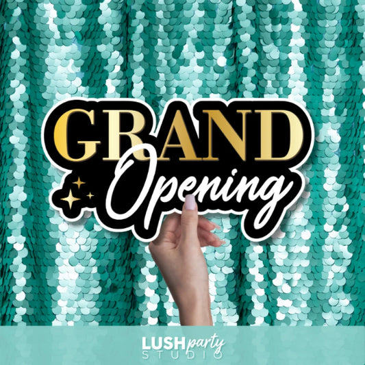 Hand holding a 'Grand Opening' photo booth prop sign for grand opening business events