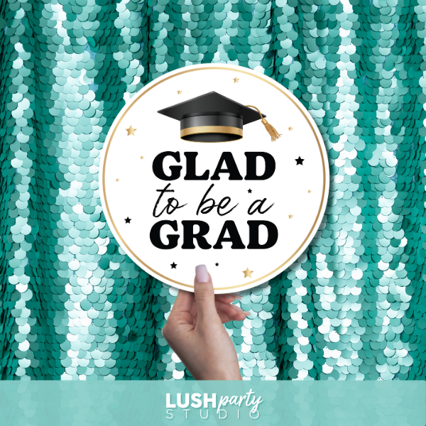Graduation-themed photobooth prop sign with 'GLAD to be a GRAD' text by lush party studio