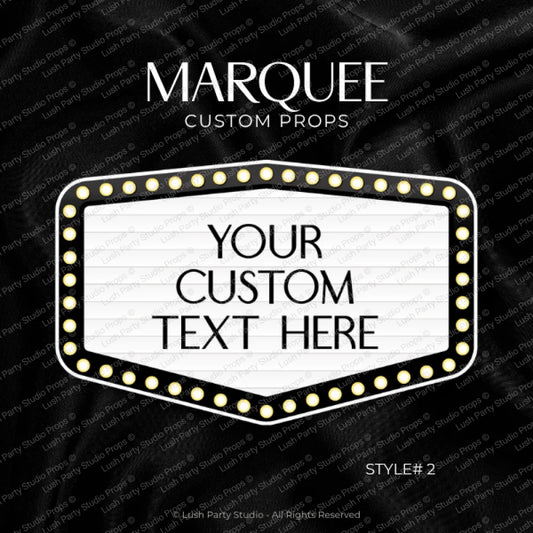 A customizable marquee sign prop template on a black satin fabric background. The white marquee features a border of gold light bulbs and placeholder text reading 'YOUR CUSTOM TEXT HERE'.