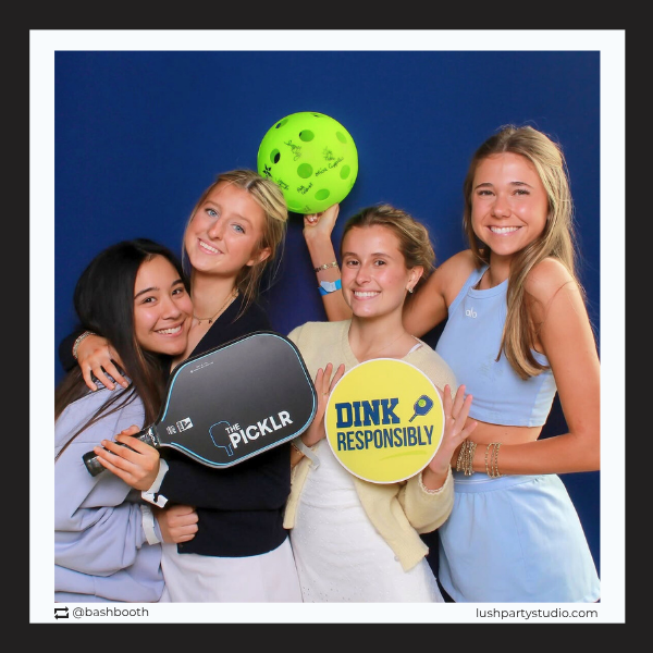 Four women posing with a pickleball photo booth props by lush party studio for sports events and parties
