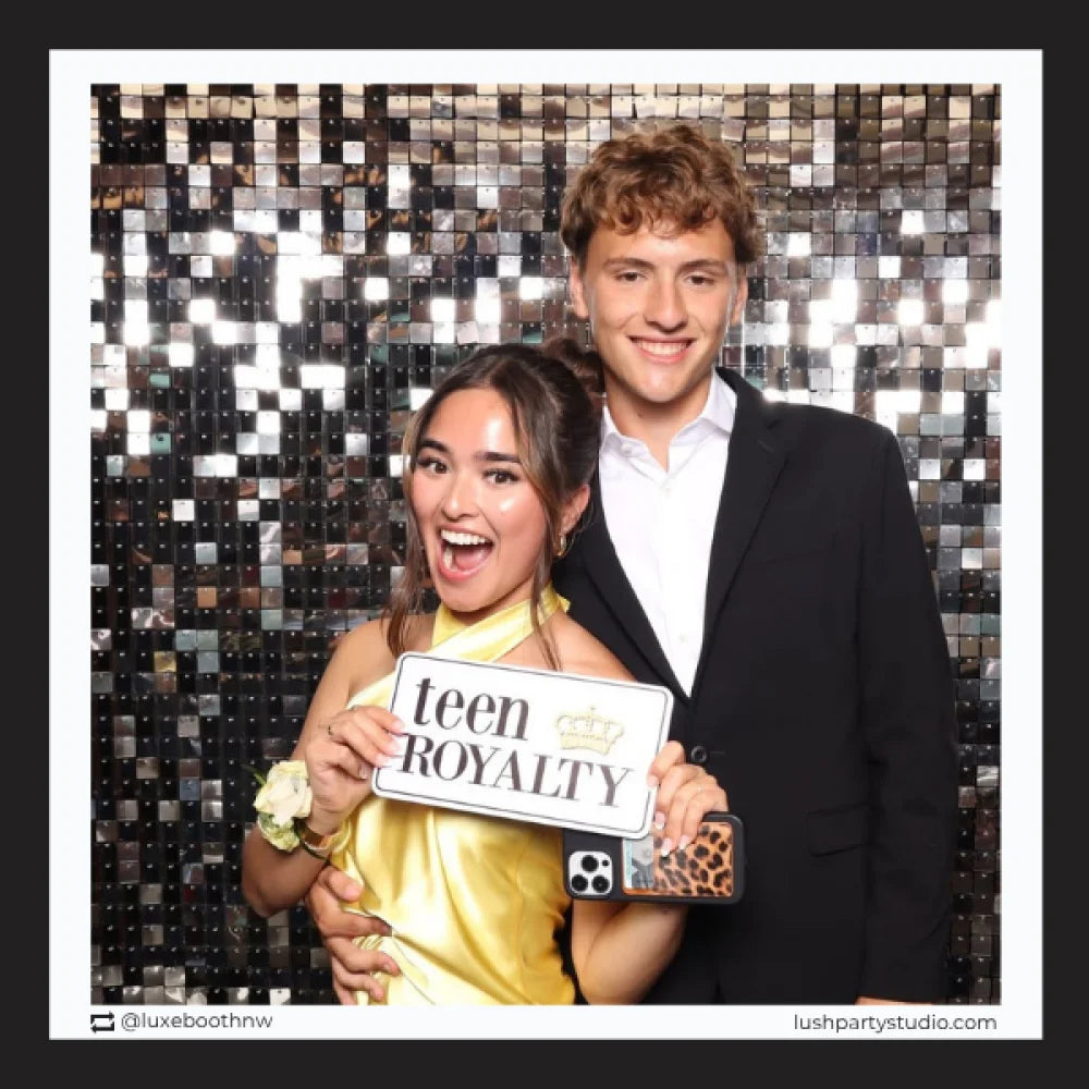 teens posing with 'teen royalty' prop sign in photobooth
