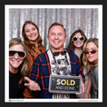 Load image into Gallery viewer, Group of people posing with a 'SOLD AND DONE' prop sign in photobooth
