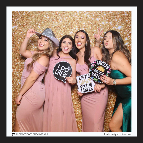 Four women posing with photo booth props by lush party studio