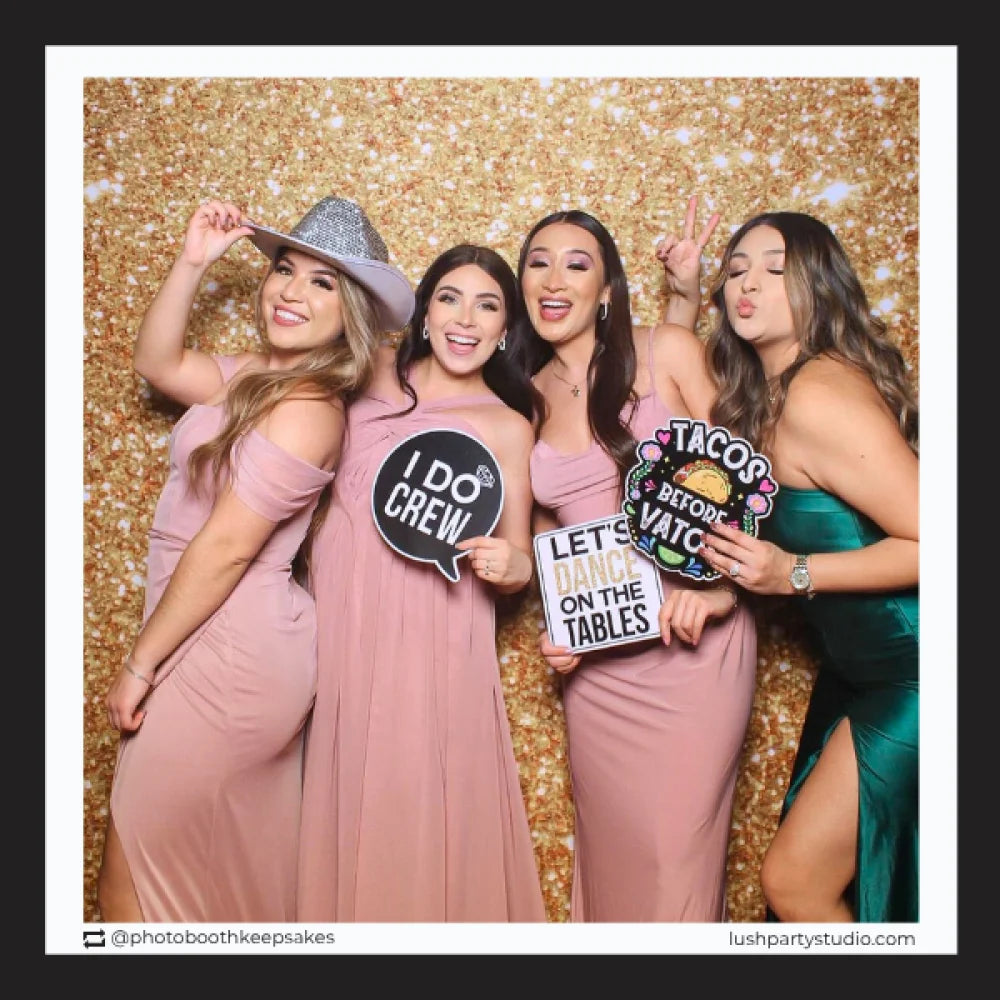 Four women posing with photo booth props by lush party studio