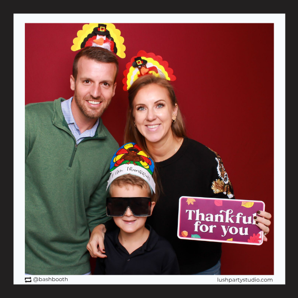 Family posing with Thanksgiving-themed props and a 'Thankful for you' prop sign by lush party studio