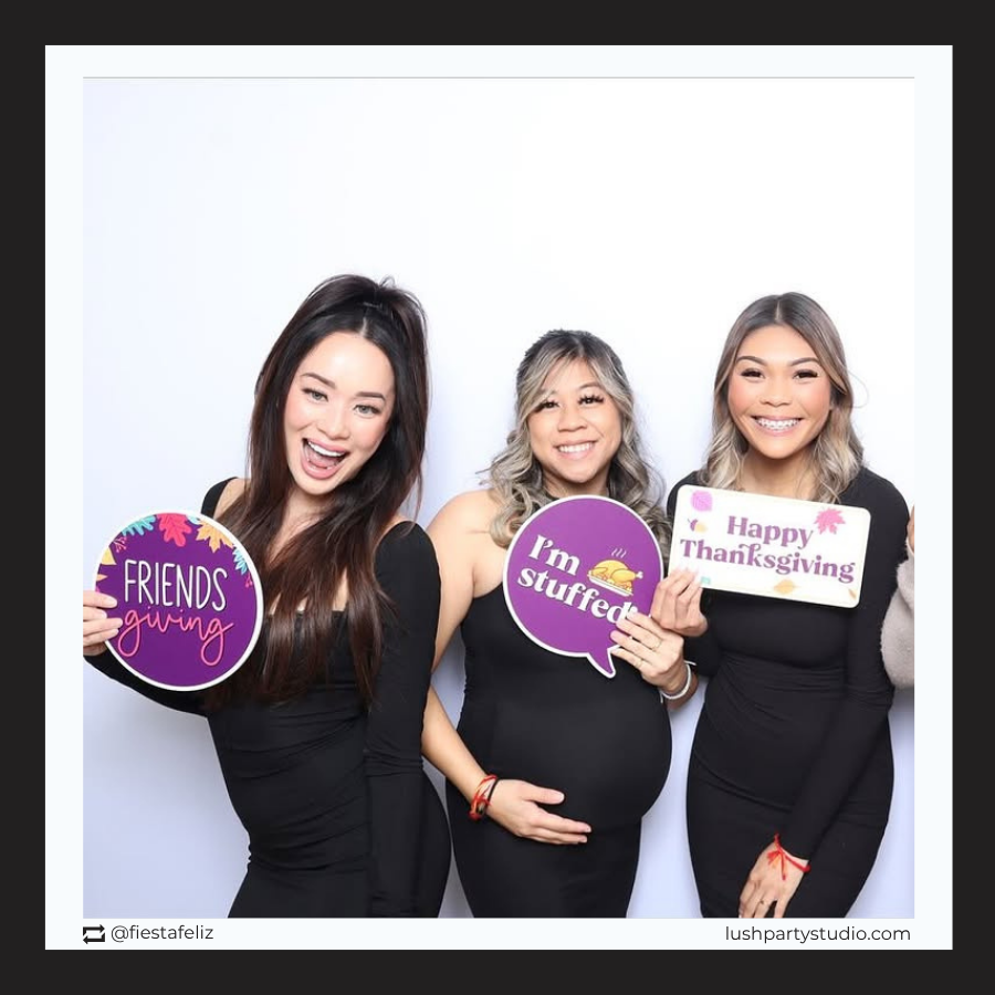 Three women holding thanksgiving photo booth prop signs by lush party studio