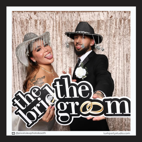 wedding photo booth with 'the bride' and 'the groom' props by lush party studio.