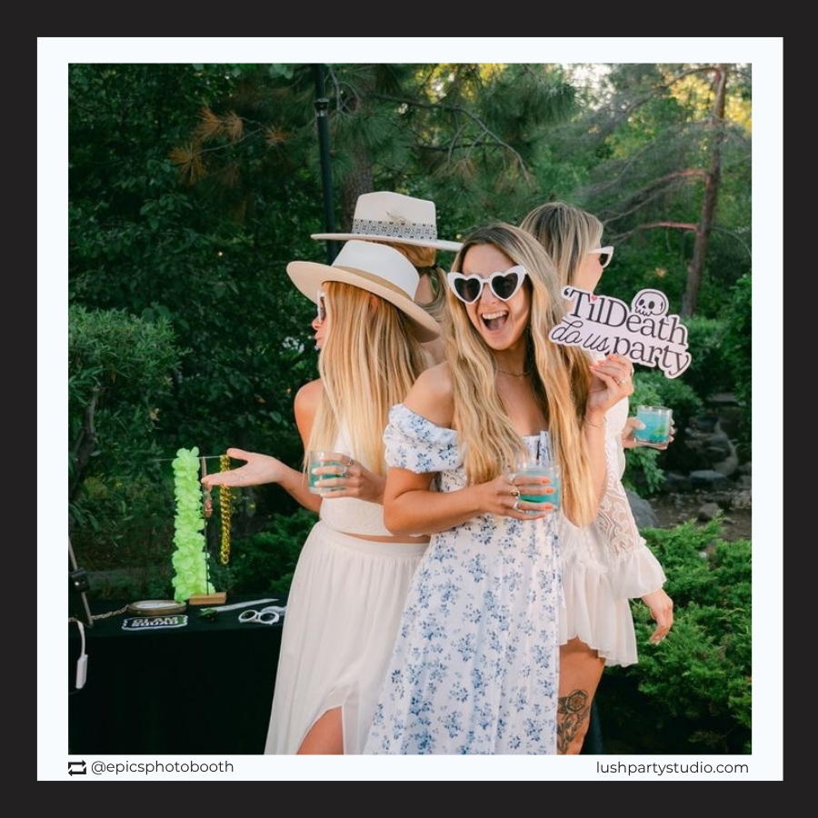 Three women at a party with drinks and a 'Til Death Do Us Party' wedding prop sign by lush party studio