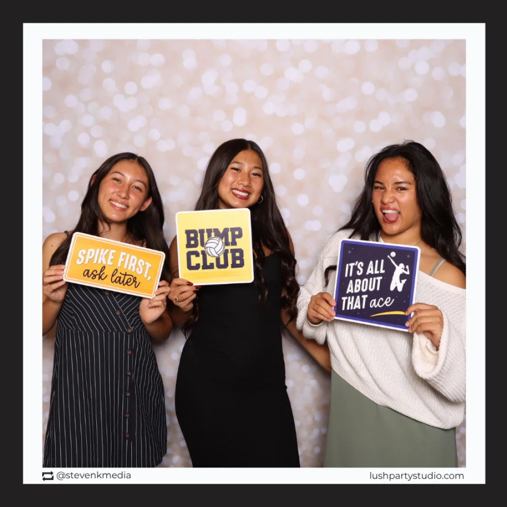 Three women holding volleyball prop signs by lush party studio