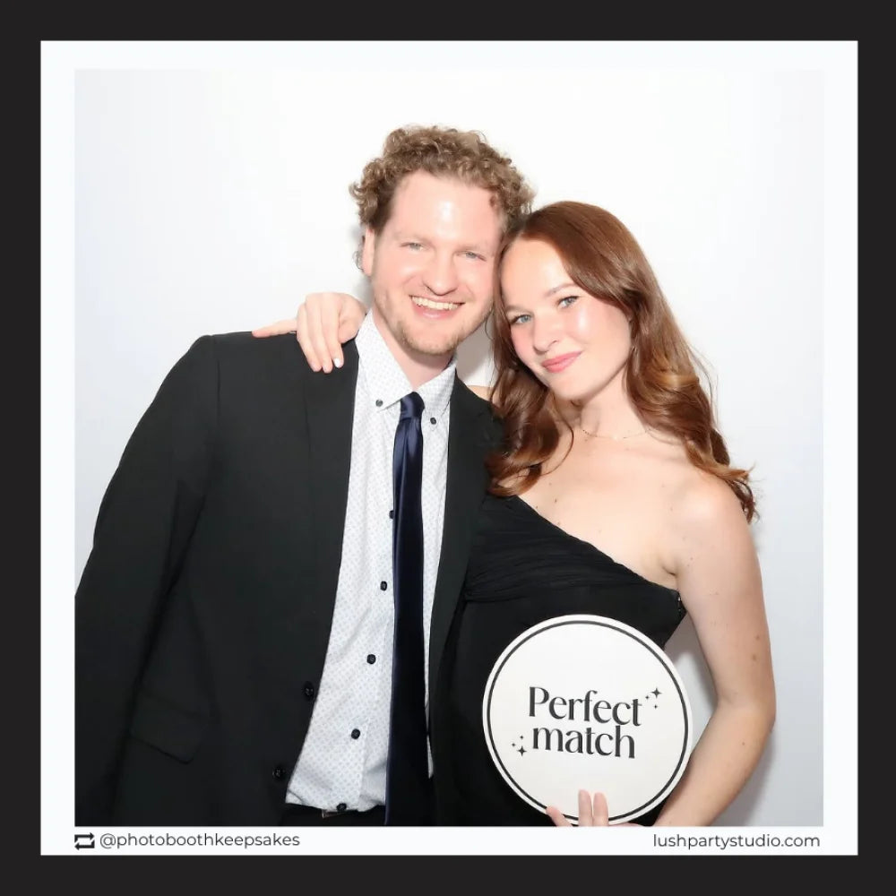Man and woman posing together with 'Perfect Match' glam wedding prop sign in photo booth by lush party studio