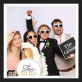 Load image into Gallery viewer, Group of people in formal attire with 'The Bride' and 'The Groom' photo booth prop signs, at a photobooth. 
