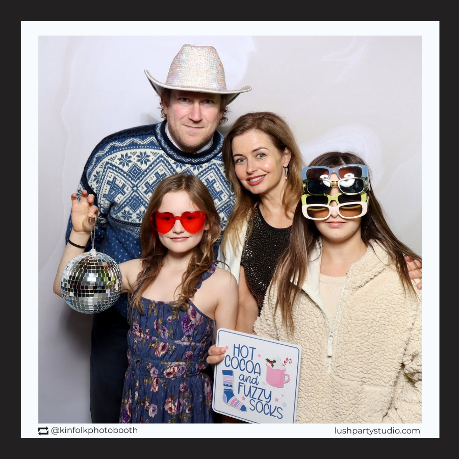 Family posing with winter wonderland photo booth props by 'Lush Party Studio' 